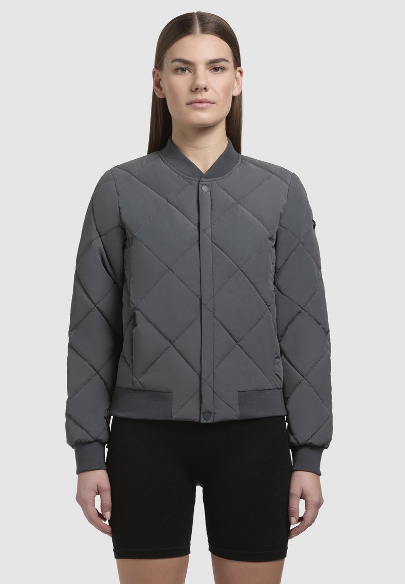 Grijze gewatteerde bomberjack met een ronde kraag, drukknopen sluiting, elastische manchetten en tailleband. Gladde textuur, minimalistisch ontwerp.