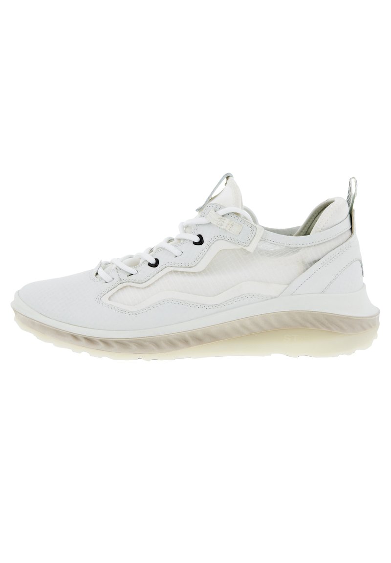 White athletic shoes with a mesh upper, textured accents, soft sole, and black eyelets. Features a pull tab on the back for easy wear.