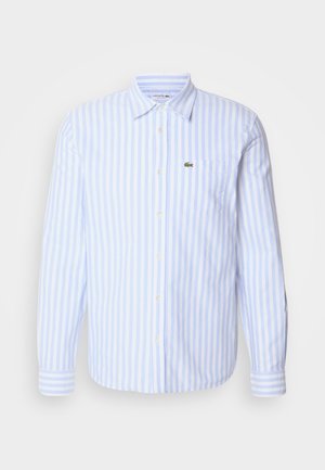 Chemise à manches longues rayée bleu clair et blanche avec un col boutonné et une poche poitrine ornée d'un petit logo brodé. Tissu en coton.