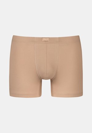 Beige cotton boxer shorts with a fitted design, featuring a soft elastic waistband and subtle stitching details.