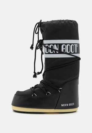 Black snow boot featuring a padded upper, adjustable laces, and a thick, textured sole. The boot has a large logo band and a sleek design.