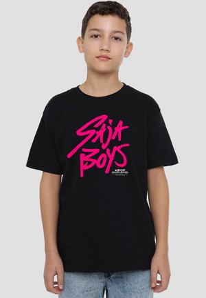 Boy wearing black T-shirt with bright pink "Saija Boys" text and small white "Kpop Demon Hunters" logo on white background.