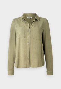 Chemise boutonnée vert olive avec deux poches poitrine, manches longues et col. En tissu texturé avec une coupe légèrement ample.