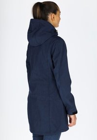 Navy blue hooded jacket with a textured fabric, long sleeves, and a relaxed fit. Features a rear vent and adjustable cuff straps.
