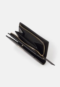 Black leather wallet with gold hardware, featuring multiple compartments and a zip closure. Smooth texture and rectangular shape.