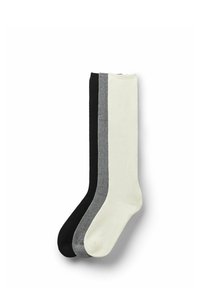 Ensemble de trois paires de chaussettes en noir, gris et crème. Fabriquées dans un tissu lisse, chaque paire de chaussettes présente un bord côtelé et un design uni.