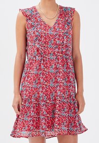 Red floral dress with a V-neck, ruffled sleeves, and a flared skirt. Features a mix of blue, yellow, and white flowers on a textured fabric.