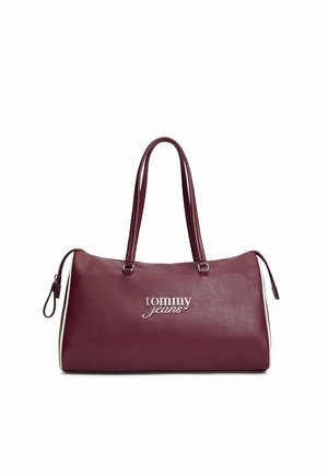 Dark red leather handbag with double handles, white side accents, and silver "tommy jeans" logo on the front, zipper closures on each side.