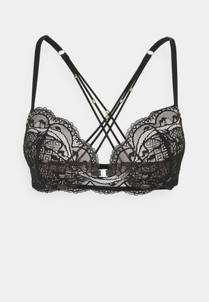 Bralette en dentelle noire avec des motifs floraux complexes, bretelles réglables, design entrecroisé à l'arrière et accents en métal doré.