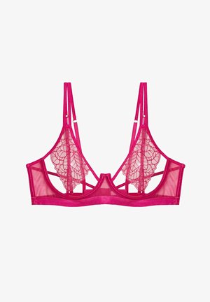 Różowy koronkowy braletka z przezroczystym siatkowym materiałem, z haftowanymi kwiatami na miseczkach i regulowanymi ramiączkami. Płaski pas pod biustem.