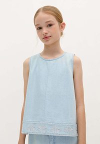 Lichtblauw mouwloos topje van denimstof, met een ronde halslijn en geborduurd bloemenpatroon langs de onderrand.