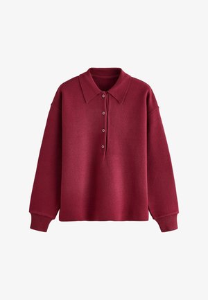 Pikkade varrukatega burgundi värvi pullover, lai krae, neli nööpi nööbiti, ja ribistatud mansetid valgel taustal.