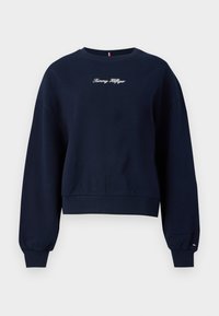Navyblauwe sweatshirt met een ronde hals, verlaagde schouders, geribbelde manchetten en zoom. Voorzien van "Tommy Hilfiger" geborduurd op de voorkant.
