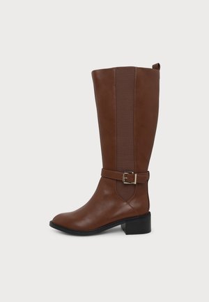 Botte en cuir marron montant jusqu’au genou, avec une bride latérale à boucle, un empiècement élastique, un bout arrondi et un talon bloc bas noir.