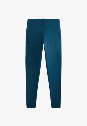 Legging tinggi pinggang, panjang penuh berwarna teal gelap. Dibuat dari kain halus yang elastis dengan jahitan aksen melengkung dan finishing yang rapi.
