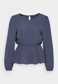 Blouse bleu marine à manches longues avec encolure ronde, taille élastique froncée, ourlet péplum et fermeture à bouton avec fente au dos.