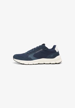 Navy blue sneakers featuring mesh and suede materials, a smooth white midsole, and a textured black outsole. Logo on the side.