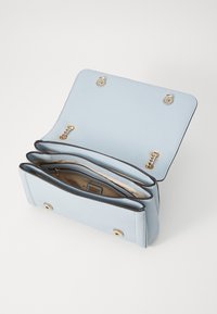Light blue synthetic handbag with a textured surface, gold hardware, a chain accent, and three inner compartments. Flap closure with snap buttons.