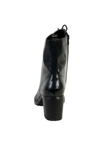Bottines en cuir verni noir avec un bout rond, un talon bloc de hauteur moyenne et une fermeture éclair sur le côté. Texture lisse et finition brillante.