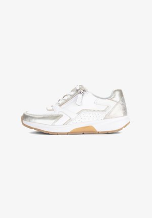 Chaussure de sport blanche avec accents argentés, design perforé, fermeture à lacets et fermeture éclair latérale. Dispose d'une semelle en caoutchouc texturée.