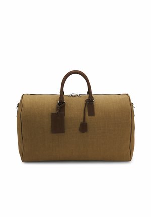 Brown canvas duffel bag with leather handles, zipper closure, and attached leather luggage tag on a white background.