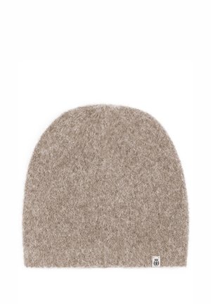 Beige knit beanie made from soft wool, featuring a rounded top and a small logo tag on the bottom right. Fuzzy texture with no visible patterns.