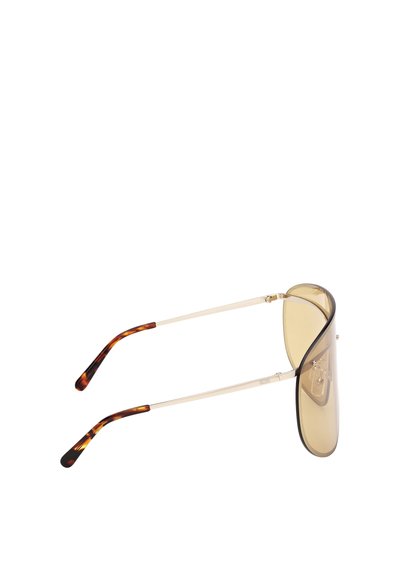 Sluneční brýle s velkými, zakřivenými jantarovými čočkami, zlatými kovovými rameny a konci s želvovinovým vzorem, zobrazené z bočního úhlu.