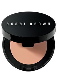 Compact circulaire noir avec le logo "BOBBI BROWN" en blanc. À l'intérieur, une poudre de teinte pêche se trouve dans une finition lisse et mate.