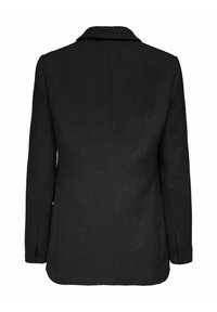 Blazer noir en tissu texturé, avec un col cranté et des manches longues, conçu avec une coupe droite et ajustée.