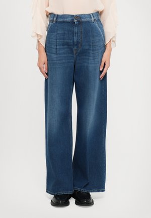 Wide-leg denim trousers in dark blue, featuring a high waist, front pleats, and stitching details. Smooth texture with a casual fit.
