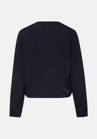 Schwarze, langärmelige, bauchfreie Jacke mit quadratischem Ausschnitt und strukturierten Schultern, von hinten vor weißem Hintergrund gezeigt.