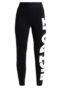 Czarne legginsy dopasowane z wysokim stanem i dużym białym napisem w pionie na prawej nogawce.