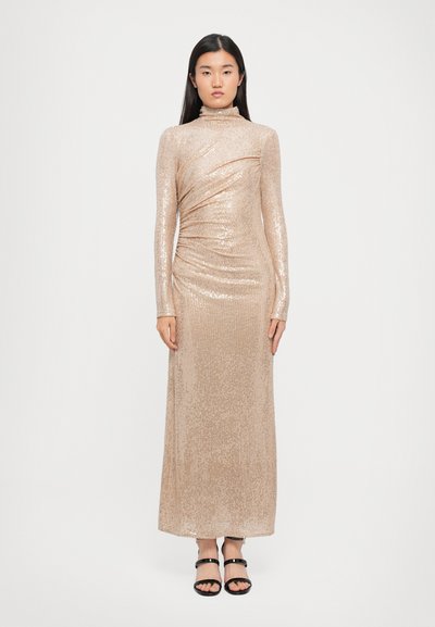 Lang, aansluitend jurkje in lichtbeige met een paillettenstructuur. Heeft lange mouwen en een hoge halslijn, met geplooide details in de taille.