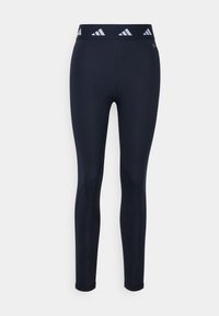 Leggings blu navy realizzati in materiale elasticizzato con un design aderente, caratterizzati da una vita alta con accenti di logo bianchi e costruzione senza cuciture.