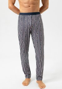 Gestreepte pyjamabroek in marineblauw met verticale lijnen. Heeft cartoongezichten in lichtgrijs en roze accenten. Zachte, rekbare stof, slanke pasvorm.