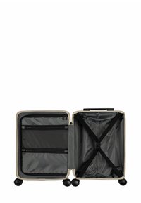 Harde koffer in crème met een zwart gestructureerd interieur. Voorzien van twee ritscompartimenten en een elastische kruissstrap voor het beveiligen van spullen.