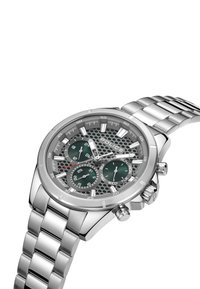 Silverfärgad klocka i rostfritt stål med en grön, texturerad urtavla, tre små urtavlor och datumvisning. Har en mesh-design och ett länkarmband.