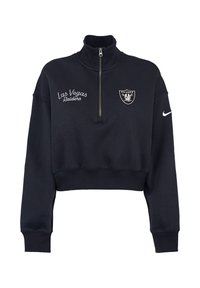 Felpa cropped blu navy con colletto alto, caratterizzata da una zip a quarto, con testo ricamato "Las Vegas Raiders" e logo della squadra. Tessuto testurizzato.