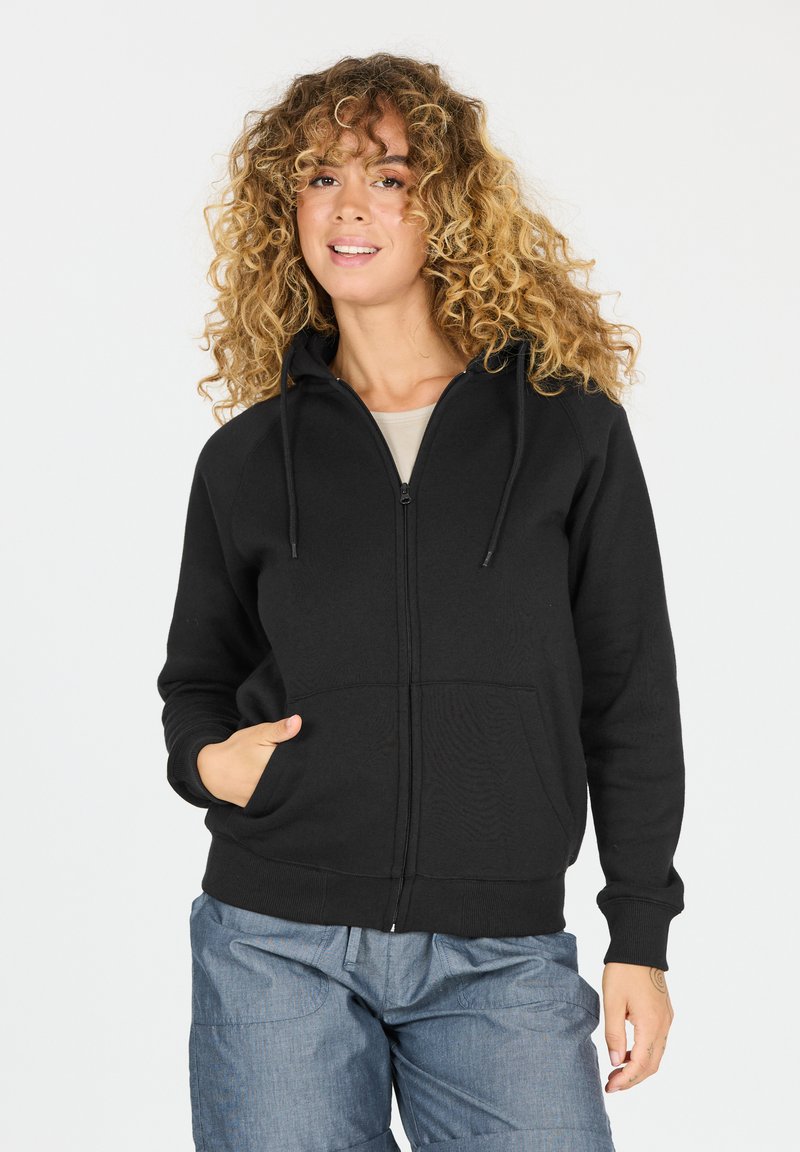 Hoodie noir zippé fabriqué en tissu doux avec une capuche, des poches avant et des poignets côtelés. Texture lisse, design décontracté.