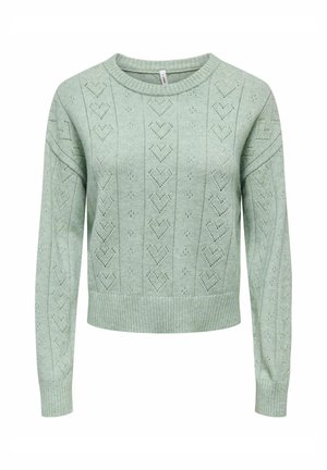 Mētagzaļš adīts džemperis ar apaļu kakla izgriezumu, rotāts ar sirds rakstu un ribotiem apakšmalas maliņām. Garas piedurknes ar brīvu piegriezumu.