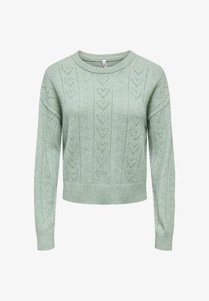 Mētagzaļš adīts džemperis ar apaļu kakla izgriezumu, rotāts ar sirds rakstu un ribotiem apakšmalas maliņām. Garas piedurknes ar brīvu piegriezumu.