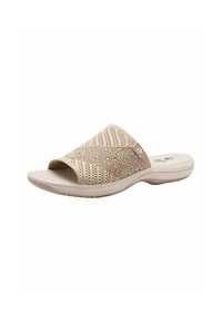 Sandale en toile beige avec une tige texturée, bout ouvert et semelle rembourrée. Présente un motif subtil et un petit emblème de la marque sur le côté.