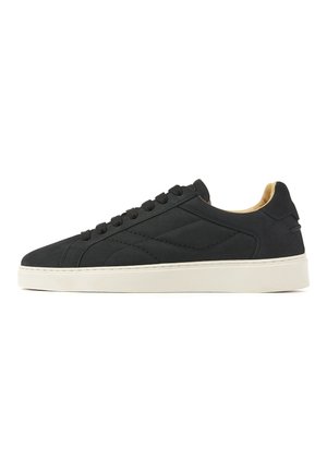 Black low-top sneaker with black laces, minimalist stitching, and white rubber sole, showing inner side profile.
