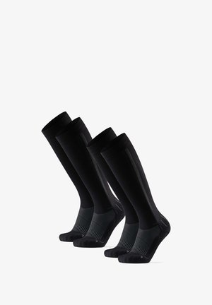 Calze nere fino al ginocchio con texture a coste, dotate di una striscia orizzontale nera a contrasto alla caviglia e con rinforzo nella punta e nel tallone.