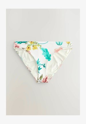 Blommig bikiniunderdel med vit bakgrund som har färgglada blommor och blad, vinklad för att visa midjan och tryckdetaljer.