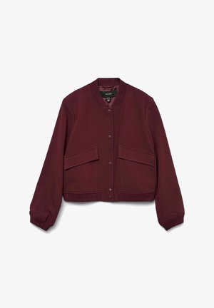 Bordowa krótka kurtka z miękkiego materiału, z okrągłym dekoltem, zapięciem na zatrzaski z przodu oraz dwoma dużymi kieszeniami naszytymi. Elastyczne mankiety.