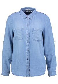 Light blue denim shirt with a collared neck, long sleeves, two chest pockets, and button closure down the front. Smooth texture, casual design.