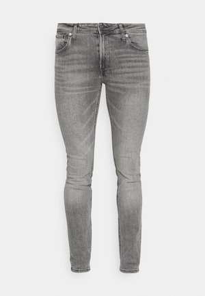 Grå denim skinny jeans med en glat tekstur, fem-lomme design og diskret falmning. Har metalhardware og lynlåslukning.