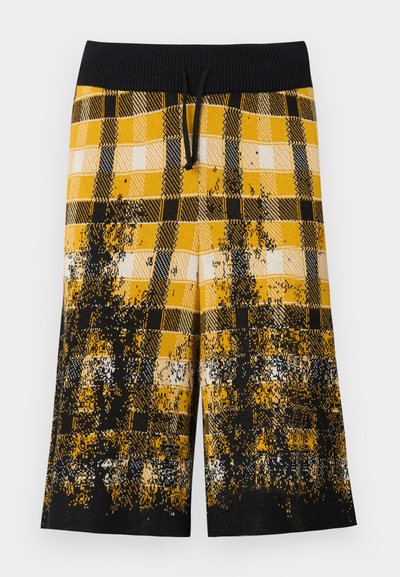 Black and yellow plaid shorts with a textured pattern, featuring a black ribbed waistband and adjustable drawstring.