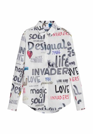 Chemise blanche à boutonnage avec divers imprimés graphiques en texte noir, rouge et bleu. Le tissu est léger ; manches longues avec poignet.